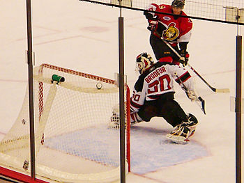 English: Puck slips Martin Brodeur for a goal....