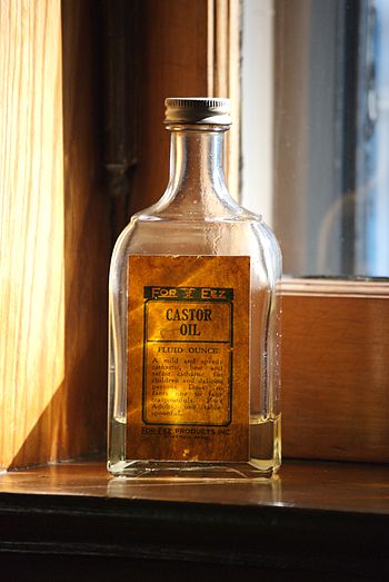 A bottle of castor oil sitting on the window s...