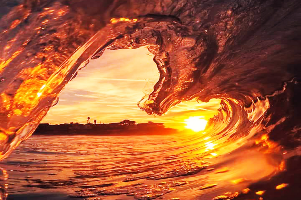 a wave tubing shaped like a heart with sunrise or sunset background