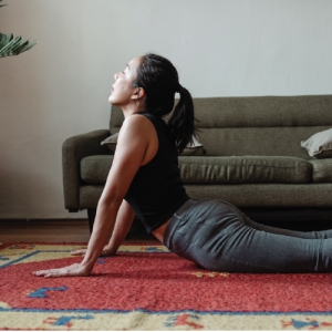 a person in their home in cobra/Bhujangasana pose