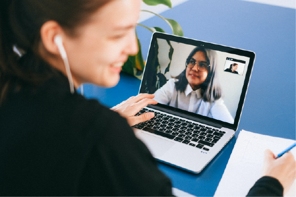 two individuals on video chat both smiling