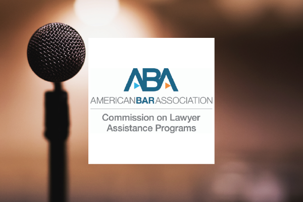 The ABA COLAP Logo comprised of the text American Bar Association Commission on Lawyer Assistance Programs with a photo of a microphone in front of a blurred room