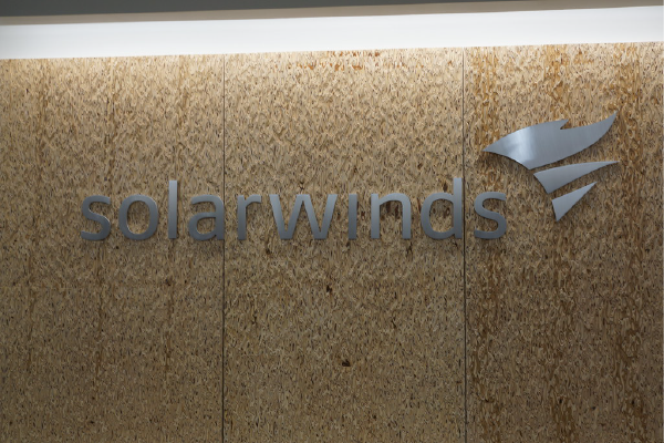 a sign for solarwinds on a light brown wall. "SolarWinds sign" by sfoskett is licensed under CC BY-NC-SA 2.0