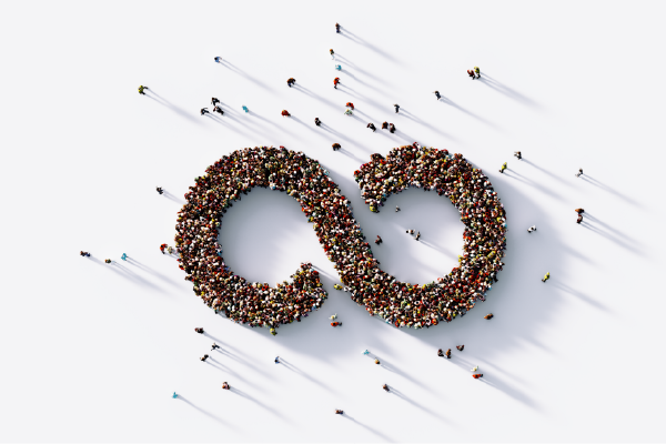 an image of an aerial view of hundreds of individuals positioned to form an infinity symbol collectively