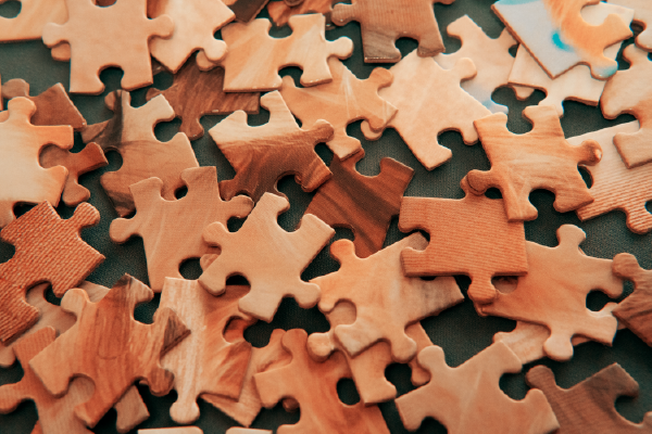 an image of puzzle pieces unsorted in a loose pile