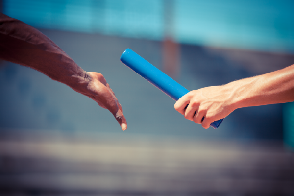 an image of a relay baton being handed off from one hand to another