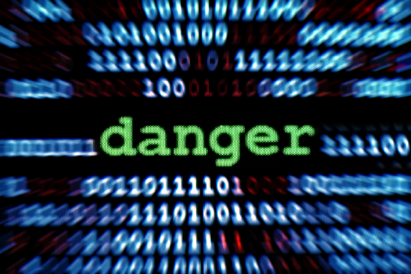an image of lines of binary code behindthe text "danger" in larger, green type