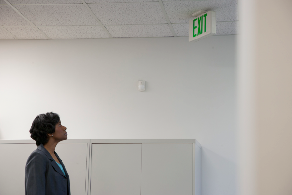 an image of a person looking at an office exit sign