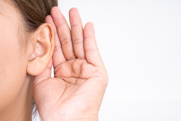 an image of a person's hand held up to their ear