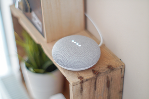 an image of a smart assistant speaker activated on a shelf